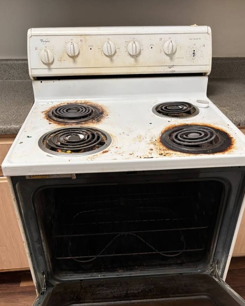 Before: stove with burnt-on grease around the burners